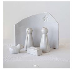 three white ceramic figurines sitting next to each other