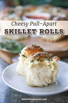 cheese pull apart skillet rolls on a white plate with text overlay that reads cheesy pull apart skillet rolls