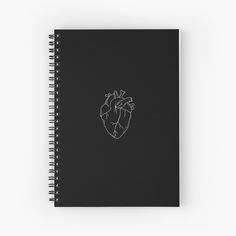 a black notebook with a white outline of a human heart on the front and side