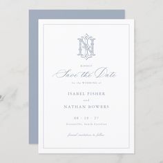 a wedding save the date card on top of a white table with silver foil lettering