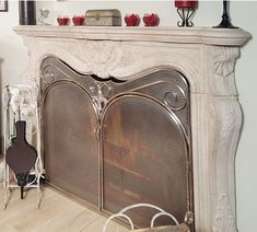 a fireplace with a fire in it sitting on top of a hard wood floor