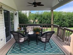 an outdoor patio with furniture on the deck and a ceiling fan hanging from the ceiling