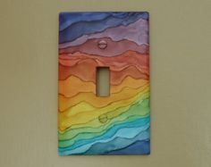 a multicolored light switch cover on a wall