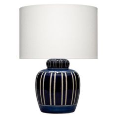 a blue and white striped vase lamp with a white shade on it's base