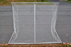 a large white net sitting on the side of a road