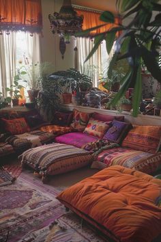 a living room filled with lots of colorful pillows and blankets on top of each other