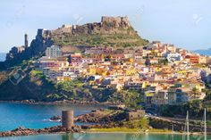 an island with many buildings and boats on the water in front of it stock photo