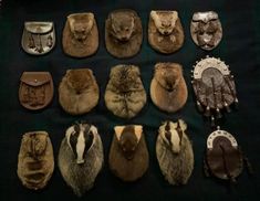 many different types of animal furs and leather gloves on a black tablecloth with white writing