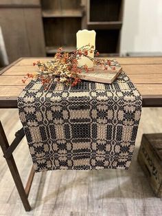 a table with a book and candle on it