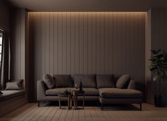 a couch and table in a room with wood paneling