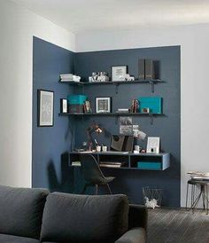 a living room filled with furniture and shelves on top of it's walls in front of a blue wall