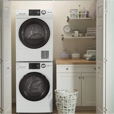 a washer and dryer sitting next to each other in a room with white cabinets