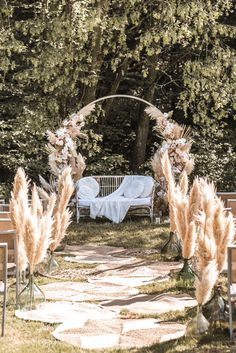 an outdoor wedding setup with chairs and flowers