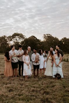 a group of people standing next to each other in a field