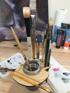 an assortment of paint brushes and other art supplies