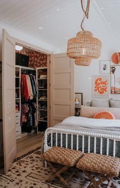 a bedroom with a bed, closet and hanging lights in the corner on the ceiling