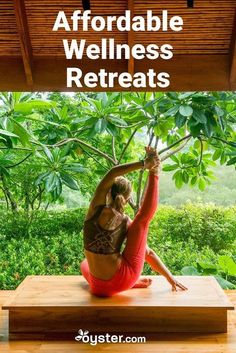 a woman doing yoga in front of a tree