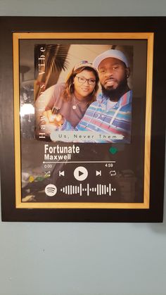 a framed photo of two people in front of a sound board with the words fortunate on it