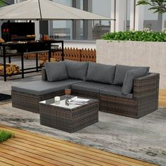 an outdoor living area with furniture and grill