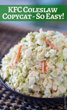 a bowl filled with coleslaw and carrots on top of a table