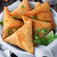 some food is on a white plate and garnished with cilantro leaves