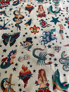 a white sheet with lots of different tattoos on it's sides and stars around the edges