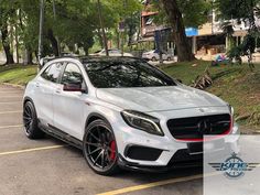 a white mercedes suv parked in a parking lot