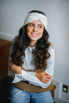 a woman wearing a white headband sitting down