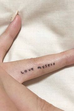 a person's finger with the word love my heart written on it, in black ink