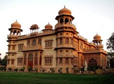 a large building with many windows and arches on the top of it's roof