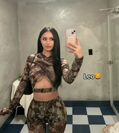 a woman taking a selfie in a bathroom