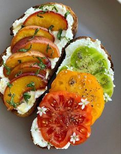 an open face sandwich with tomatoes, avocado and tomato slices on toasted bread