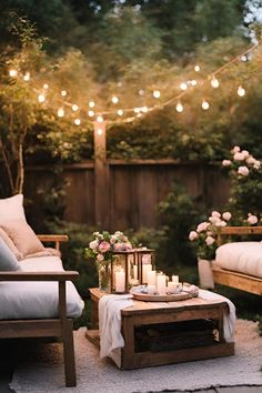 an outdoor seating area with candles and flowers