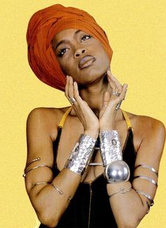 a woman with an orange turban and silver bracelets