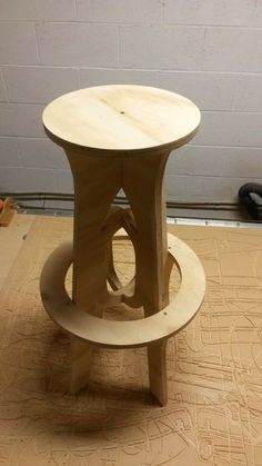 a wooden stool sitting on top of a hard wood floor