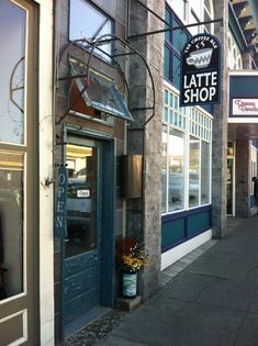 a storefront with the door open on a city street