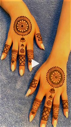 two hands with henna tattoos on them