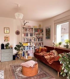 a living room filled with furniture and lots of books