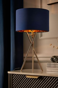 a blue lamp sitting on top of a table