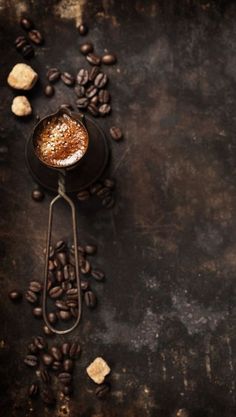 a cup of coffee and some cookies on a table