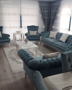 a living room filled with blue couches and chairs