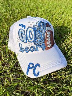 a baseball cap with the words go bear po on it sitting in the green grass