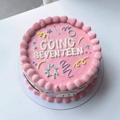 a pink birthday cake with writing on it