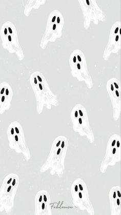 a pattern with black and white spooky ghost faces on a light gray background