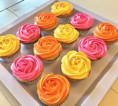 there are many cupcakes with different colored frosting