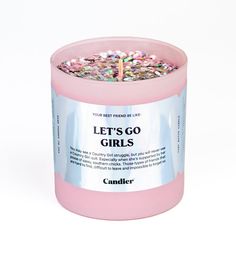 a pink candle with sprinkles on it that says let's go girls