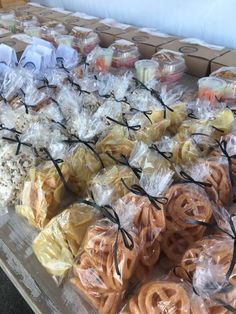 many different types of pretzels wrapped in cellophane and sitting on a table