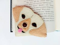 a bookmark with a dog's face on it and a book in the background