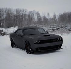 a black sports car parked in the snow