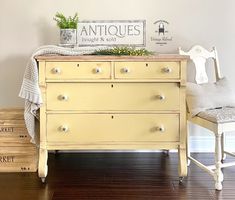 an antique dresser and chair are sitting on the floor in front of a sign that says antiques